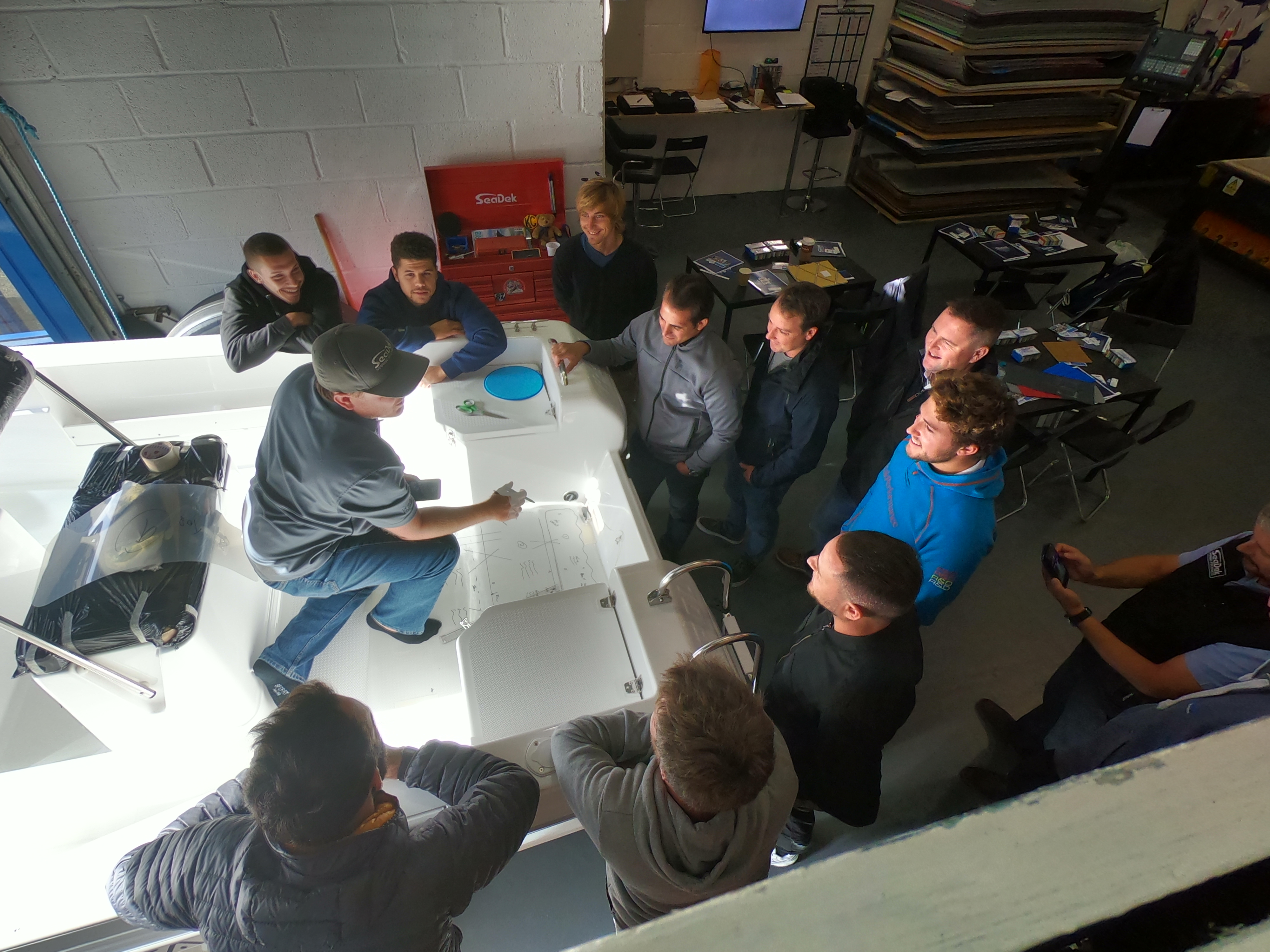 Jarrods Johnson showing a group of individuals how to template a boat 