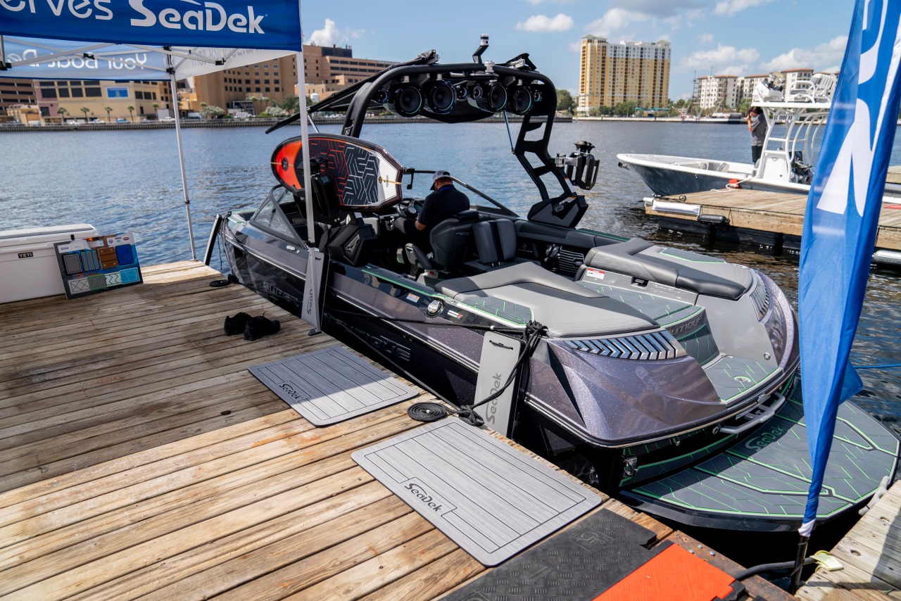 A docked Nautique G23 with 3 seadek flat fenders hanging on side